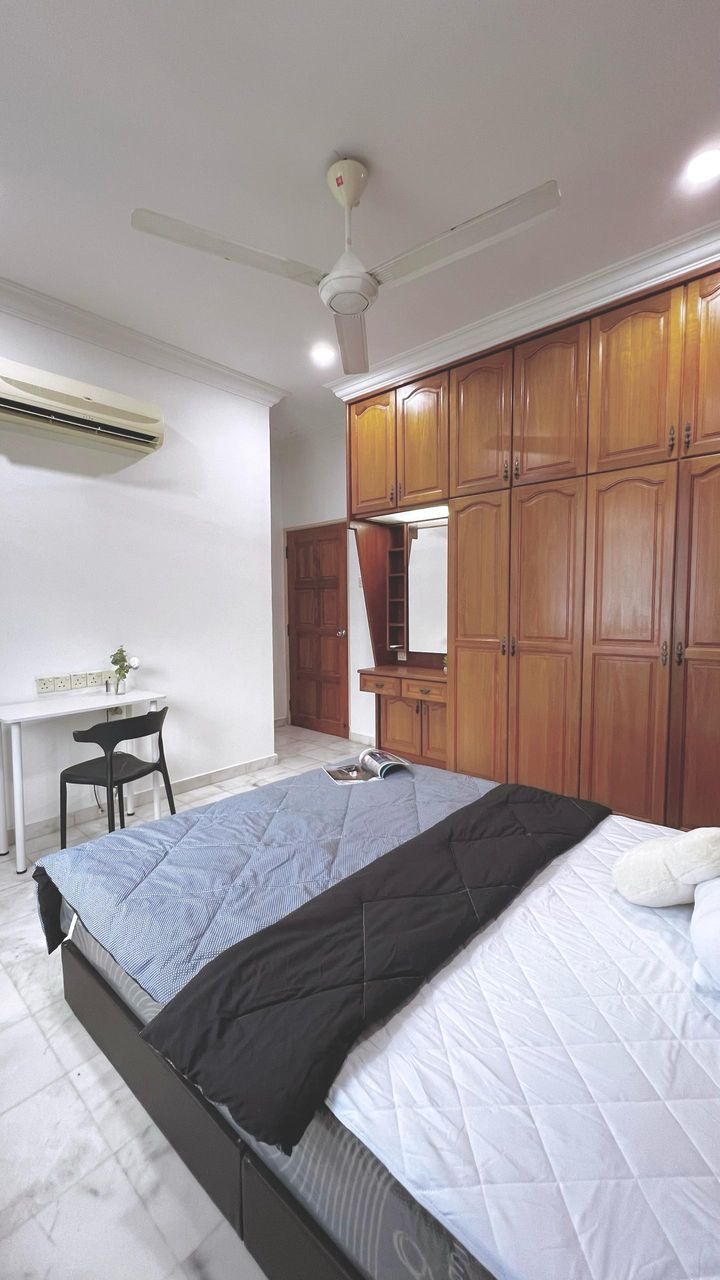Junior master room for rent in Gelugor with bed, desk, and wardrobe